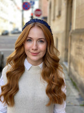 Load image into Gallery viewer, Navy ruffled headband worn over long auburn waves, shown in a front-facing outdoor portrait.