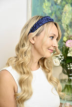 Load image into Gallery viewer, Navy ruffled headband worn over loose blonde waves, shown in right-facing profile indoors.
